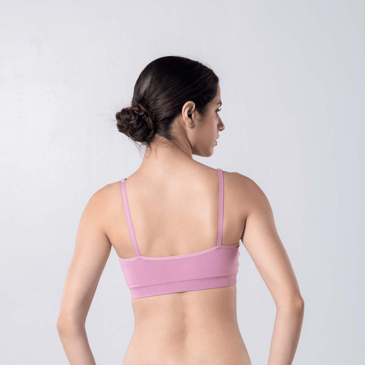 Feel Active Bra in Snow Pink, back view worn by model.