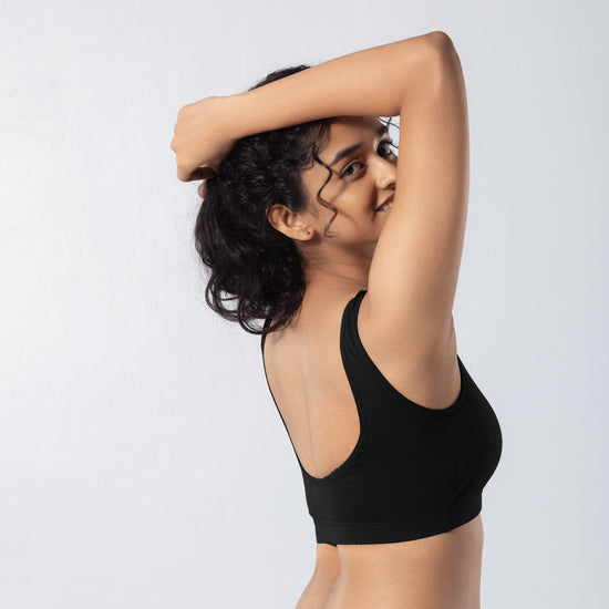U-Back (N) Active Bra in Black, side view worn by model.