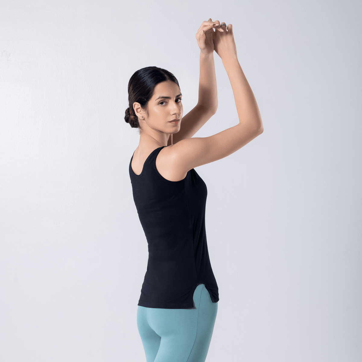 LadyO Alexa-F Mid Length Tank Top in Black, side pose worn by model.